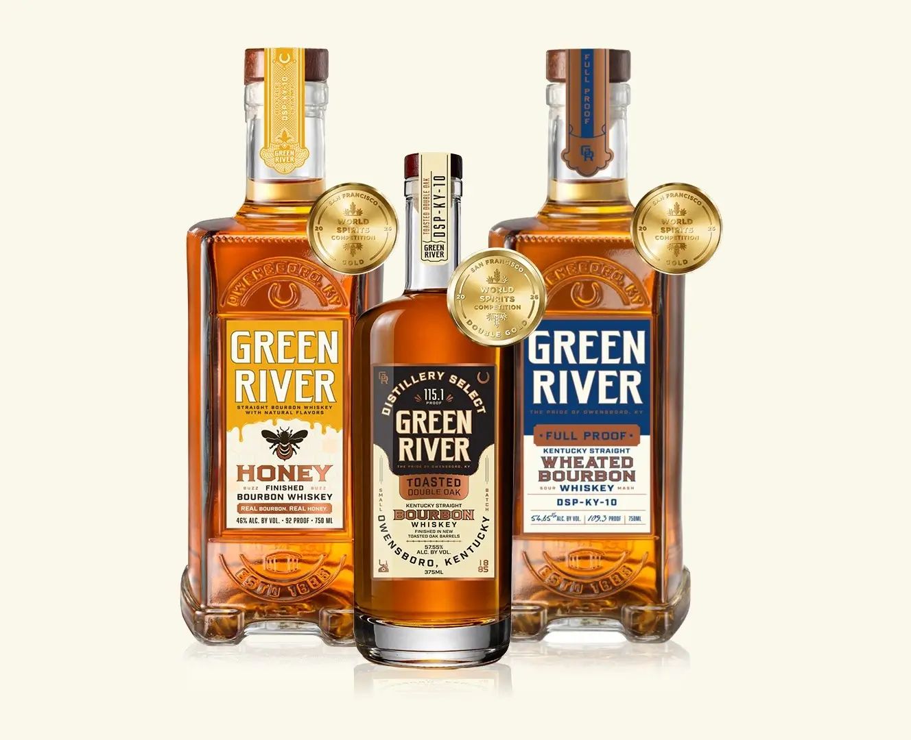 Three Green River bourbon bottles: Honey, Toasted Single Barrel, and Full Proof varieties with gold medallion seals